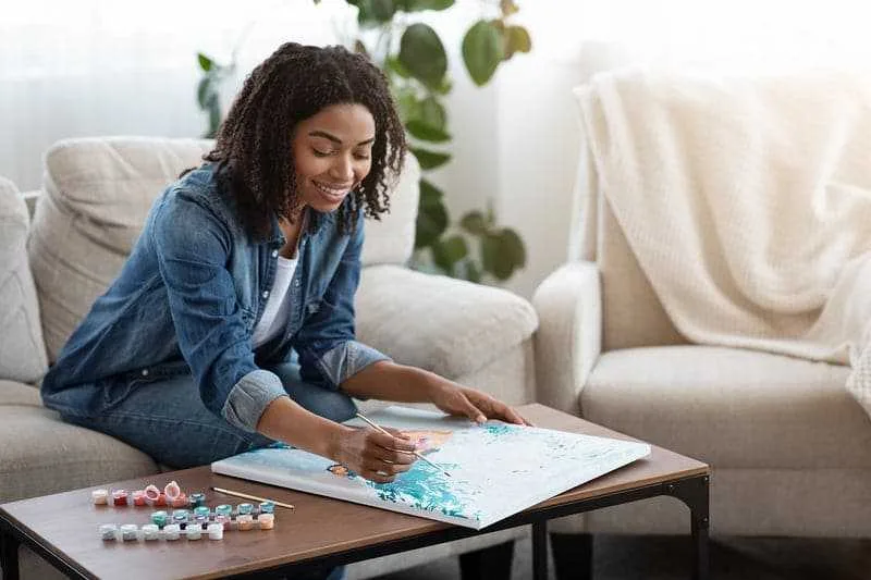 Person relaxing while painting by numbers